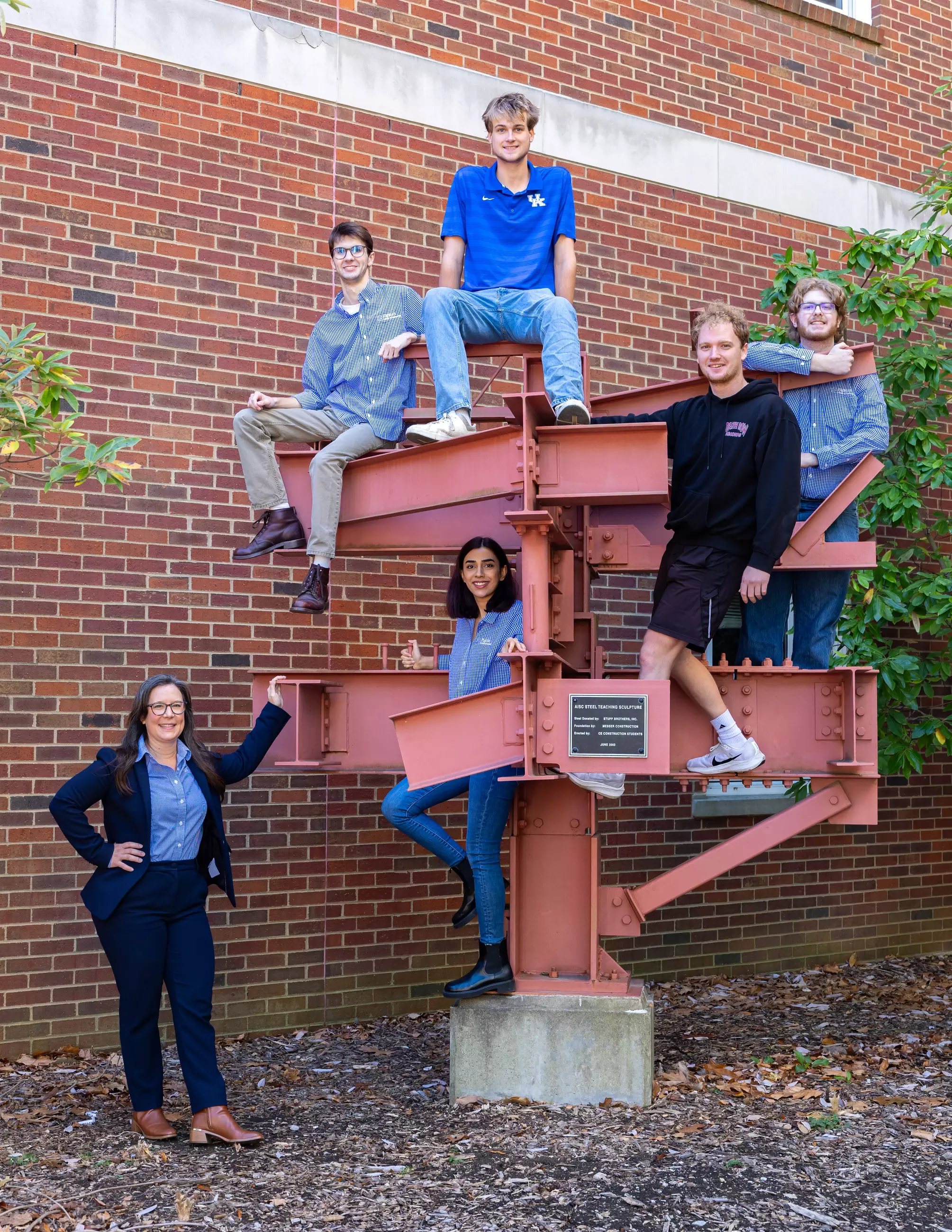 Image of students climbing on steel structure.